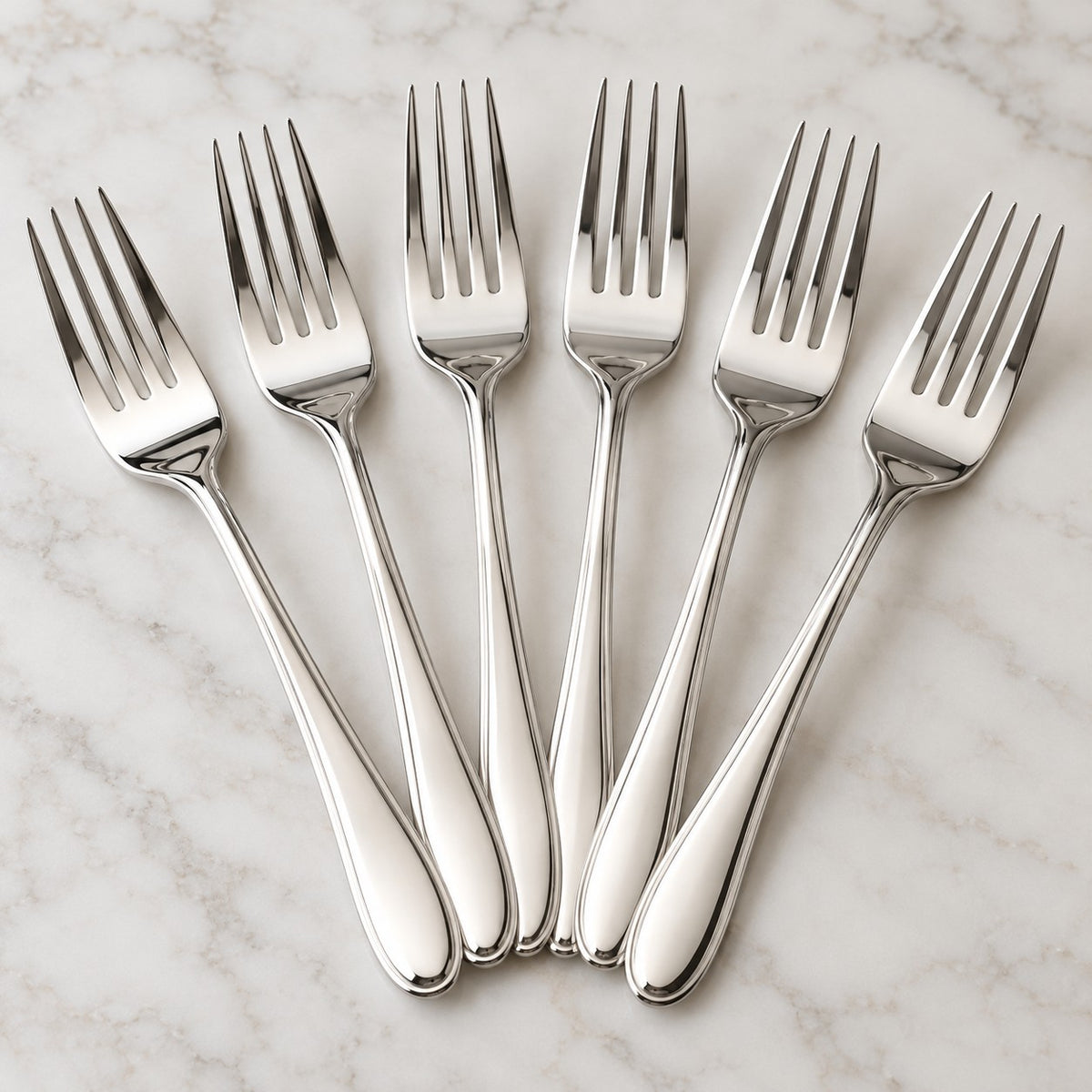 A close hero arrangement shows the bright polished finish of the silver party forks.