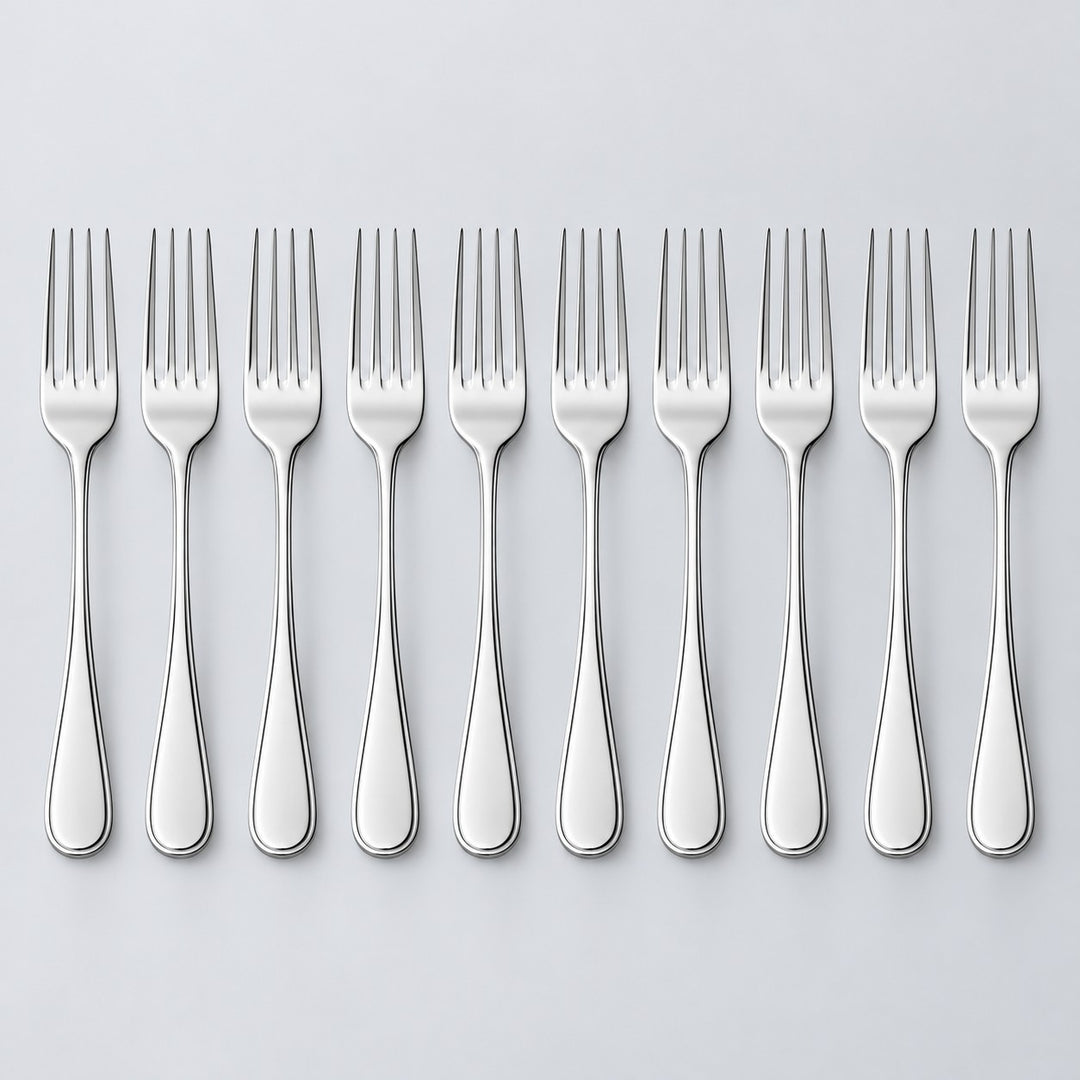 Ten silver disposable forks stand in a row against a light silver studio background.