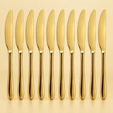 Ten gold disposable knives stand in a row against a pale gold studio background.