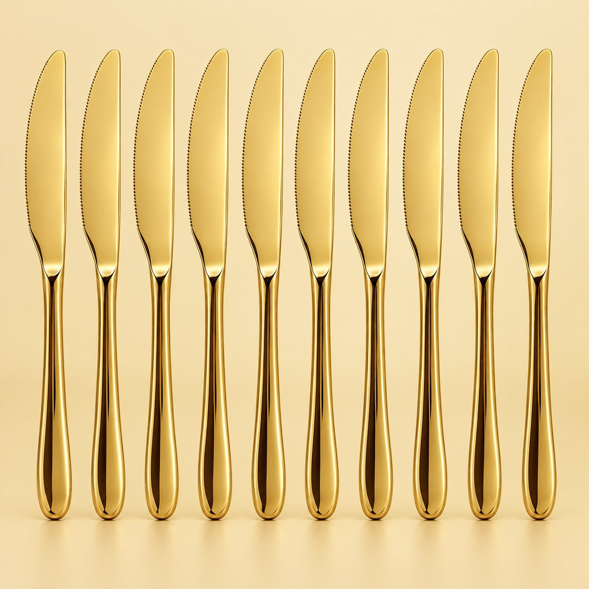 Ten gold disposable knives stand in a row against a pale gold studio background.