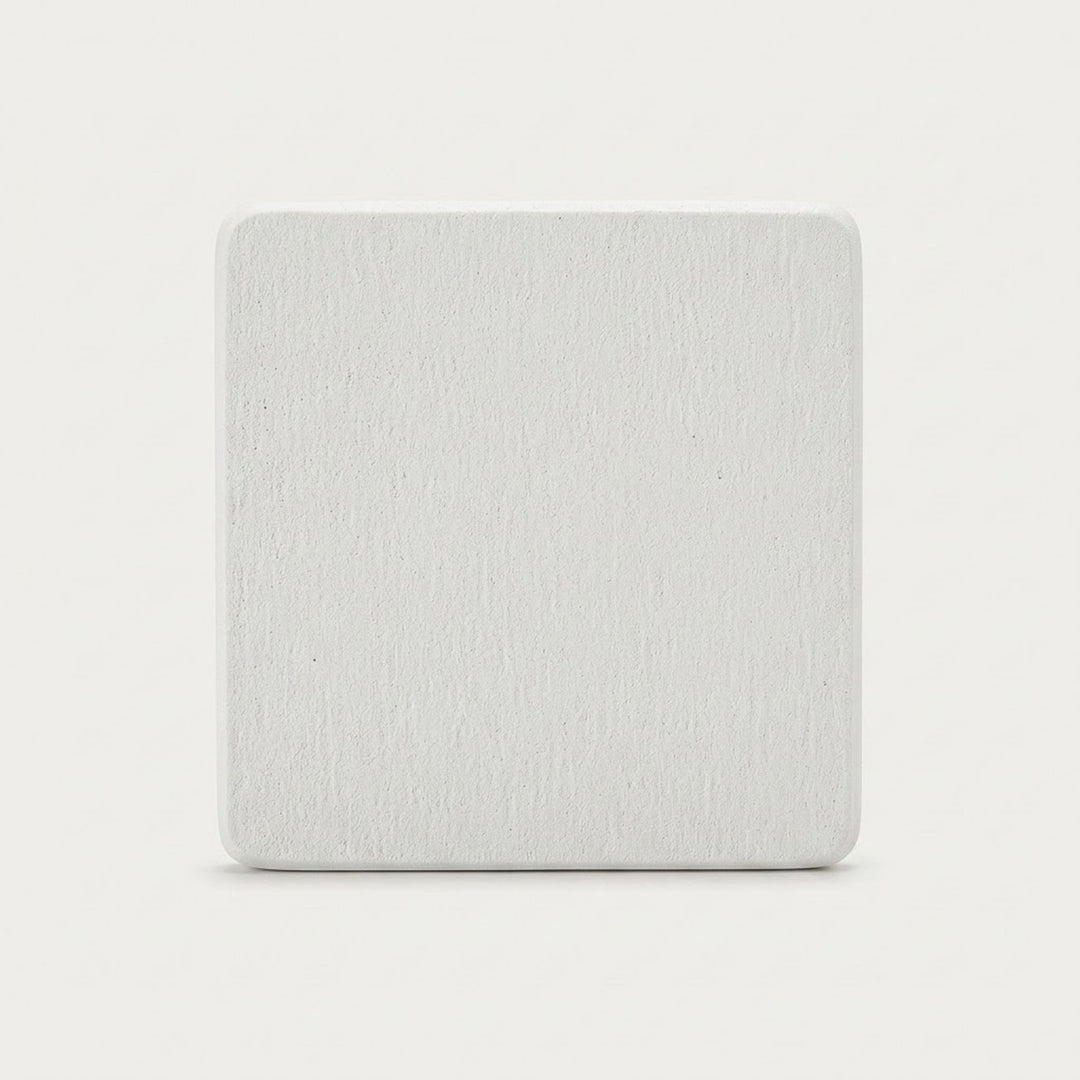 A square, light gray textured tile or coaster with rounded corners, centered on a clean white background.