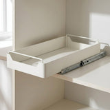 A white pull-out desk organizer tray mounted on a shelf with metal drawer slides, shown in a clean interior setting.