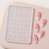 A clear silicone nail stamping tray with embossed bow patterns, shown next to four false nails decorated with pink and white ombre gradients and white bow designs, all on a soft pink background.