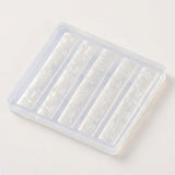 A translucent plastic rectangular mold with five vertical compartments, each containing an embossed floral and bow pattern, shown on a plain light background.