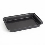 A rectangular black non-stick baking pan with raised rimmed edges, shown at an angle on a clean white background.