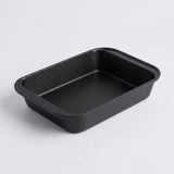 A black rectangular baking pan with rounded corners, photographed on a clean white background.