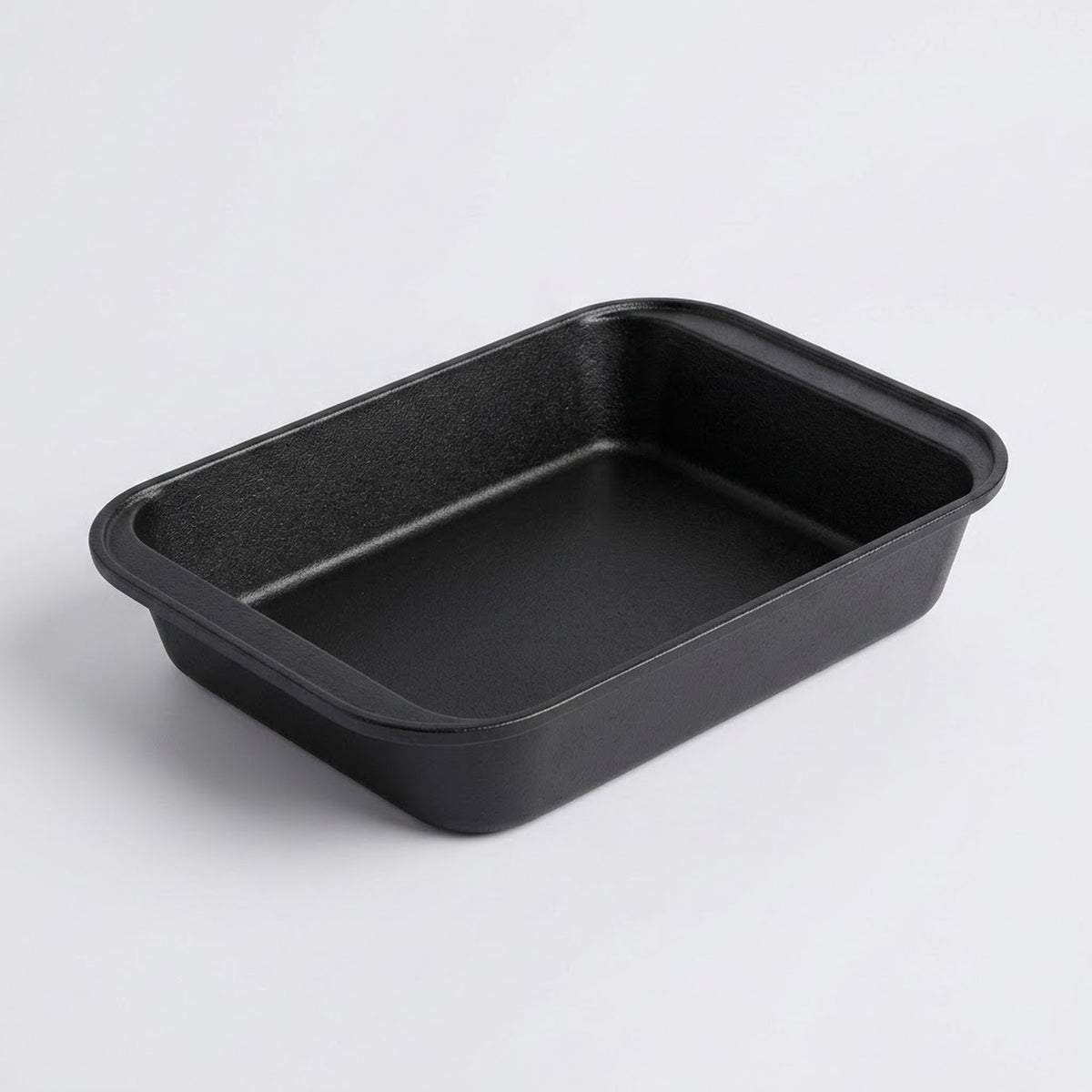 A black rectangular baking pan with rounded corners, photographed on a clean white background.