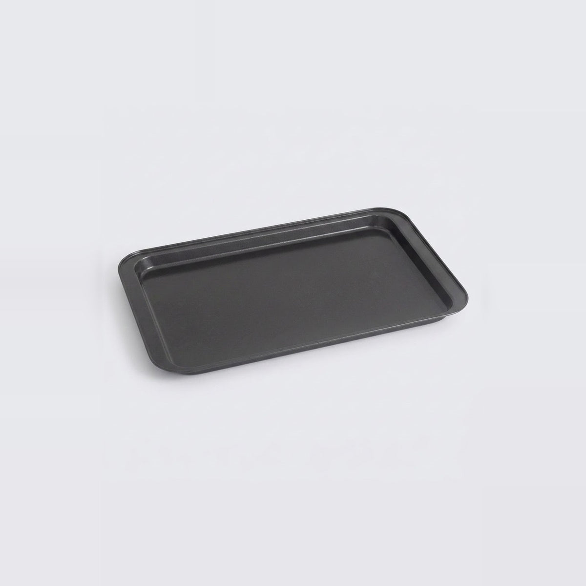 A rectangular black baking tray with raised edges, shown at an angle on a light gray background.
