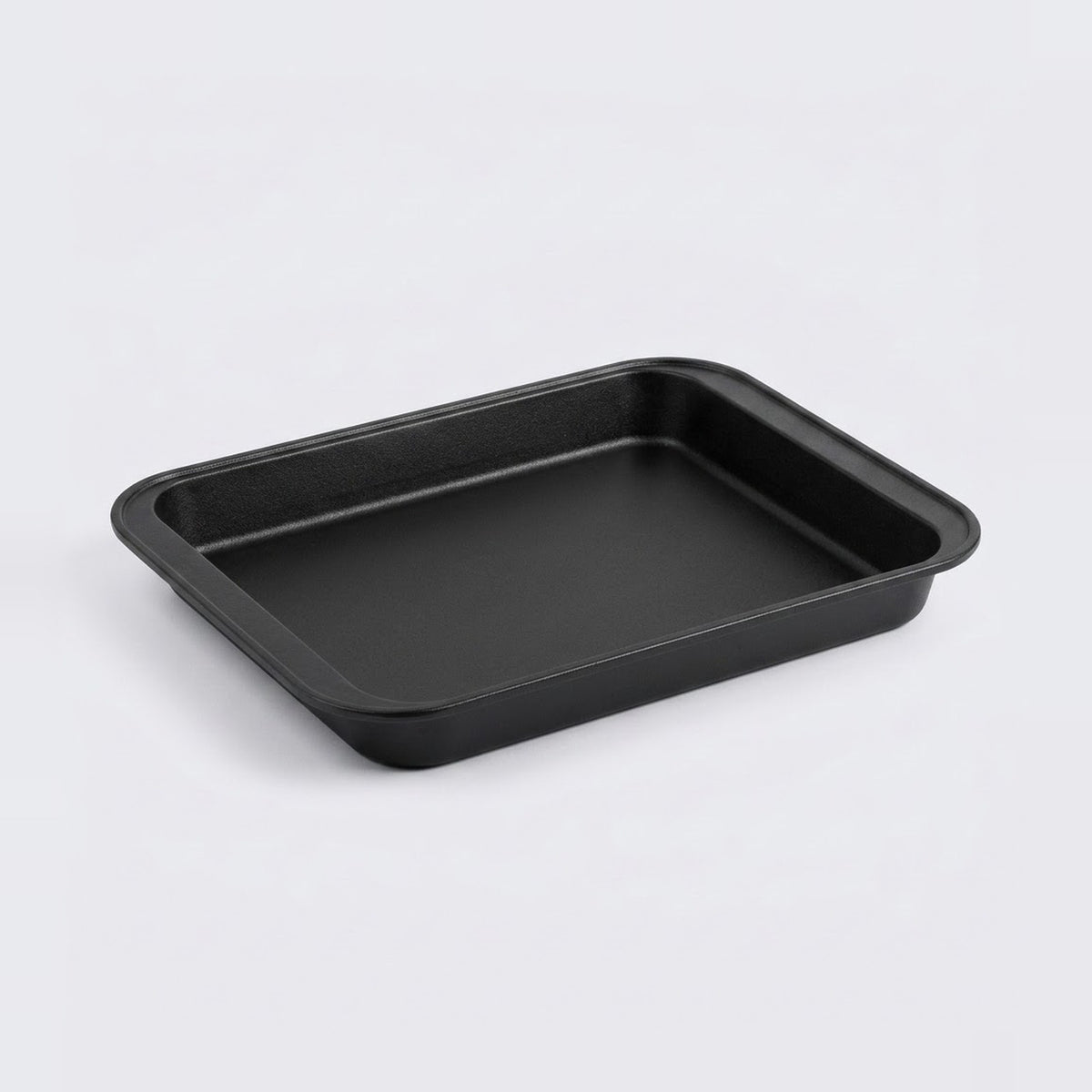 A black rectangular baking pan with rounded corners, photographed on a clean light gray background.