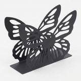 A black metal butterfly bookend with a double-layered butterfly design, photographed on a clean white background.