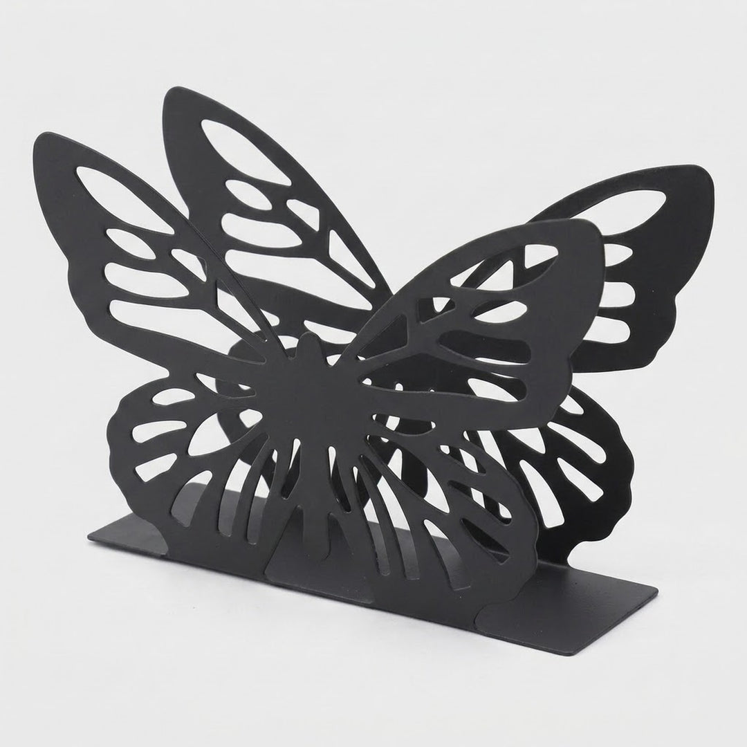A black butterfly-shaped bookend with intricate cutout wing patterns and a flat rectangular base, photographed on a light gray background.