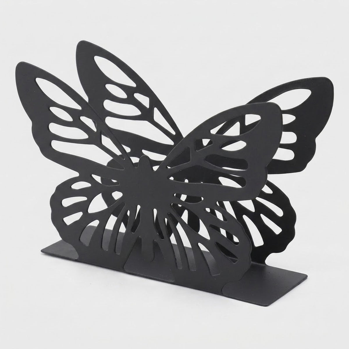 A black butterfly-shaped bookend with intricate cutout wing patterns and a flat rectangular base, photographed on a light gray background.