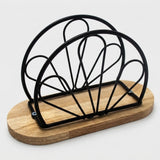 A black metal wire rack with a semi-circular fan design mounted on a round light brown wooden base, shown on a light gray background.