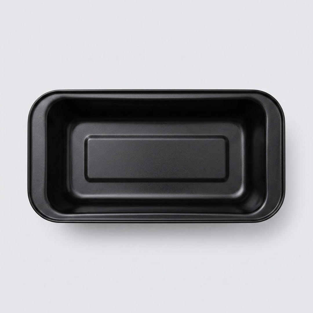A black rectangular shallow tray with rounded corners, photographed from directly above on a light gray background.