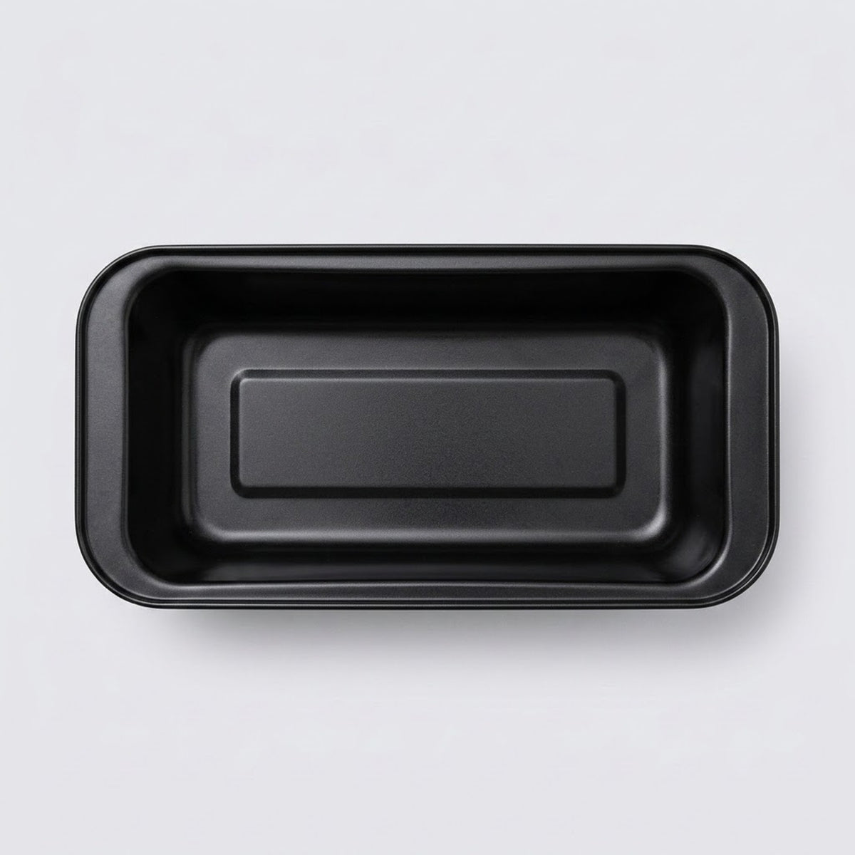A black rectangular shallow tray with rounded corners, photographed from directly above on a light gray background.