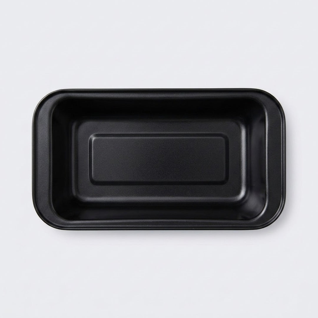 A black rectangular shallow tray with rounded corners, photographed from directly above on a light gray background.