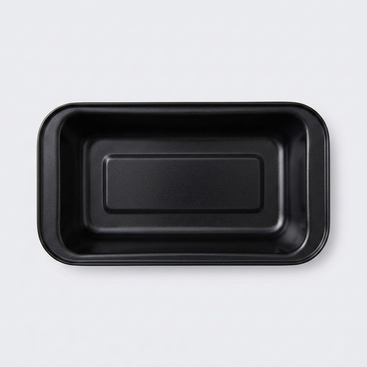 A black rectangular shallow tray with rounded corners, photographed from directly above on a light gray background.