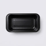 A black rectangular shallow tray with rounded corners, photographed from directly above on a light gray background.