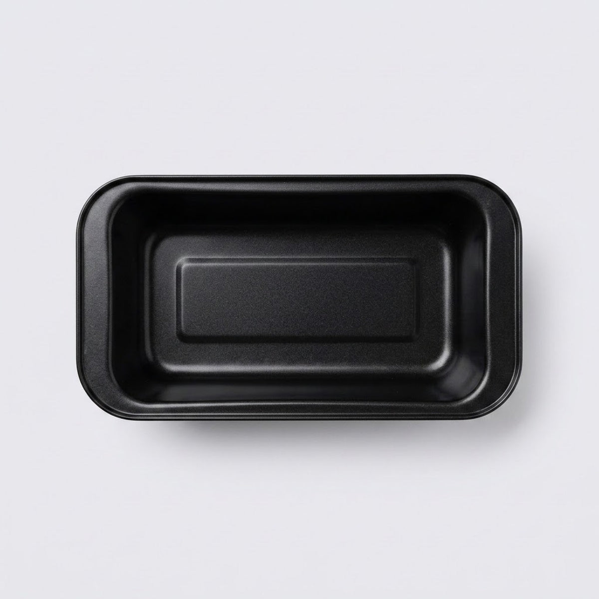 A black rectangular shallow tray with rounded corners, photographed from directly above on a light gray background.
