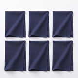 Six folded navy blue fabric napkins arranged in a 2x3 grid on a plain white background.