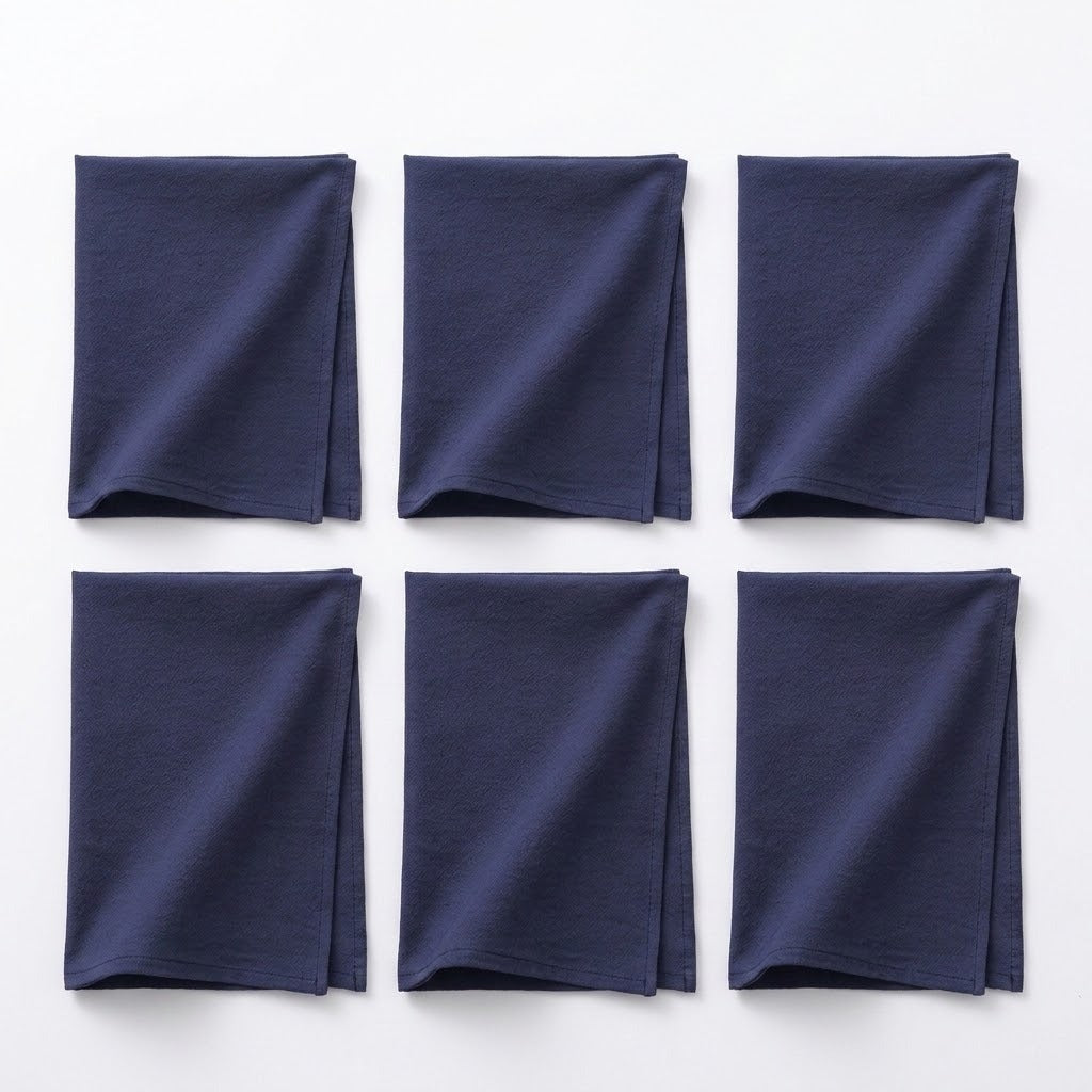 Six folded navy blue fabric napkins arranged in a 2x3 grid on a plain white background.