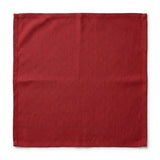 A square red cloth napkin or handkerchief with a visible linen-like texture, laid flat against a clean white background.