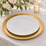 Gold Beaded Charger Plate under a white dinner plate at a wedding table setting.