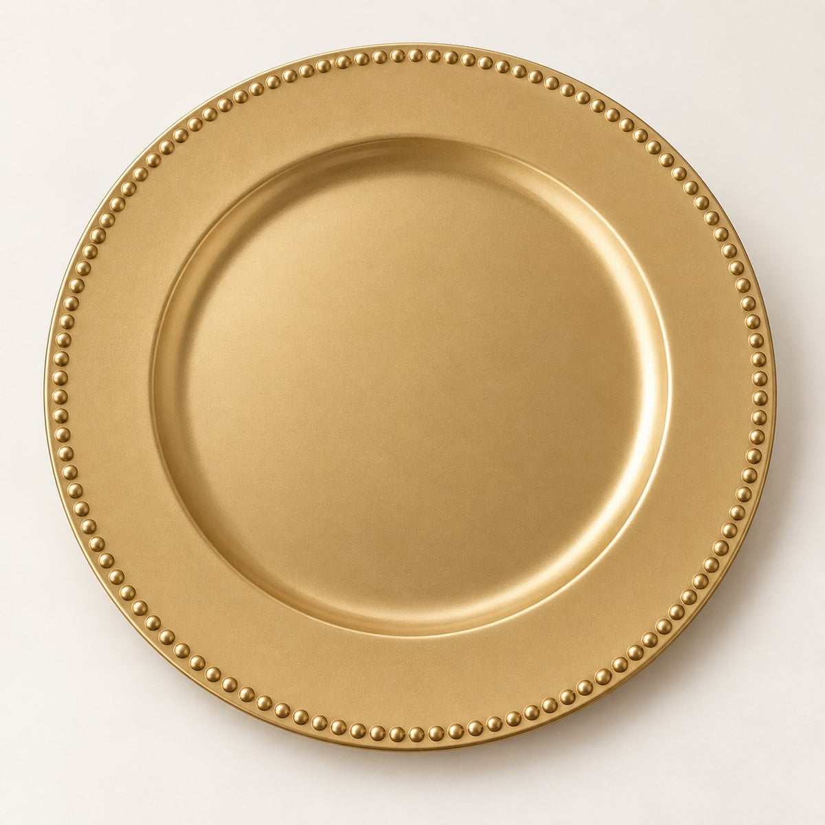 Gold Beaded Charger Plate showcasing its raised bead rim on a warm studio surface.