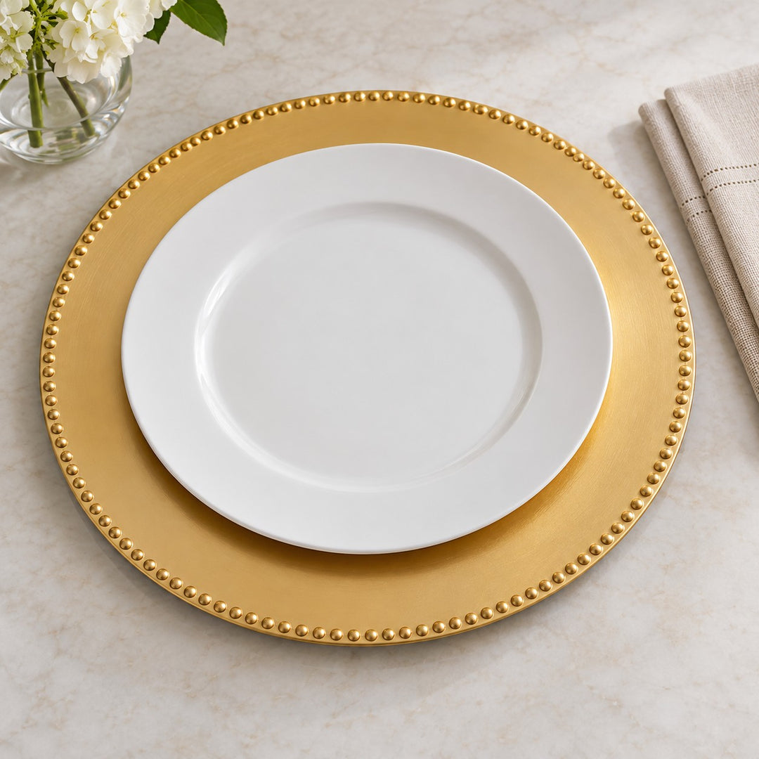 Gold Beaded Charger Plate beside a standard dinner plate and folded napkin for scale.