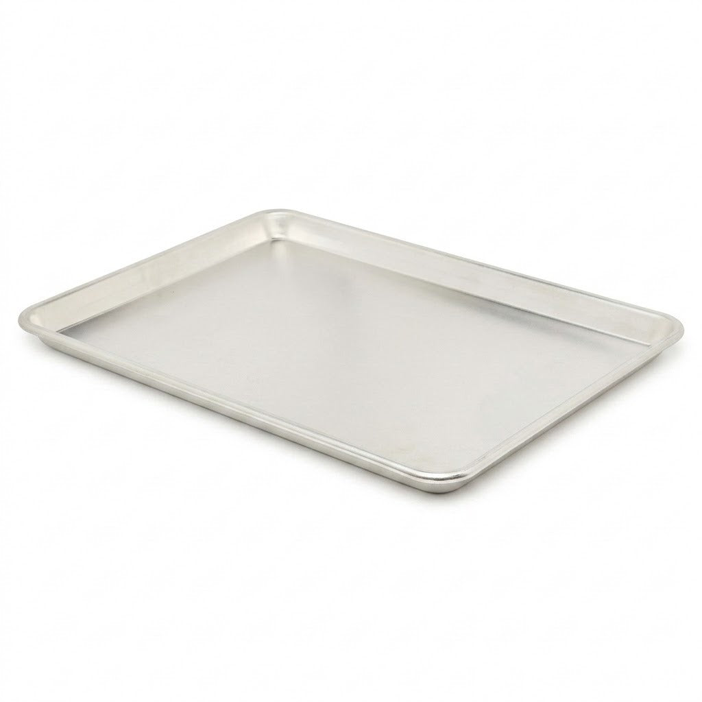 A rectangular metal baking pan with raised edges, shown at an angle on a plain white background.