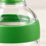Close detail shows the Salad Dressing Shaker’s smooth green band and clear plastic finish.