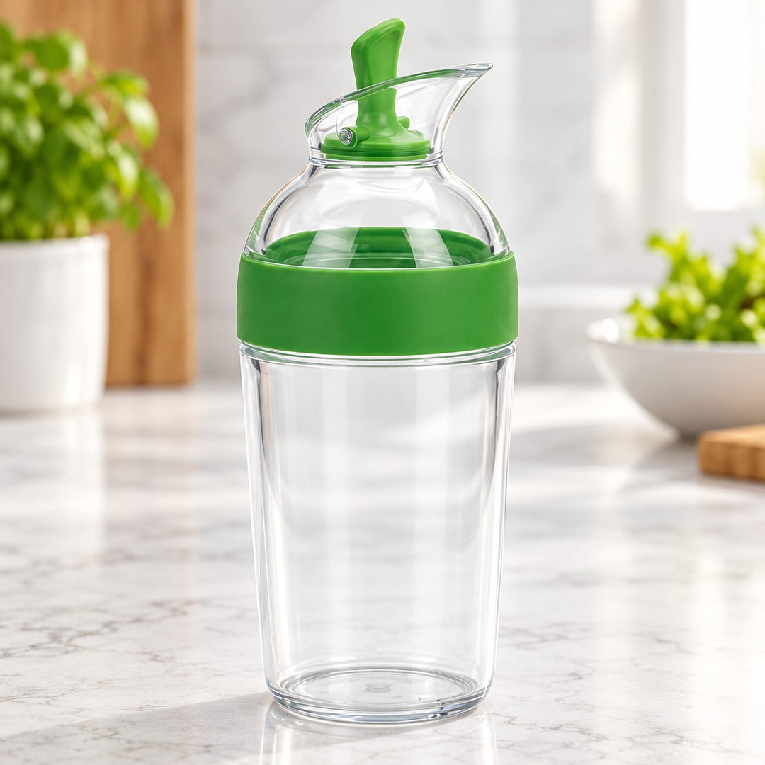 Green Salad Dressing Shaker highlights its easy press lever and clear pouring spout in a bright kitchen.