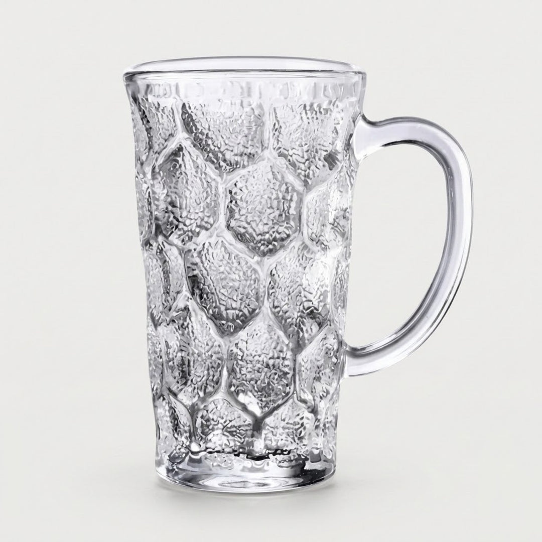 A clear textured glass mug with a honeycomb pattern and a curved handle, shown on a light gray background.