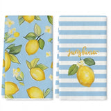 Two kitchen towels with lemon and white flower prints, one solid light blue and one light blue and white striped with gold script reading 'Sunshines'.
