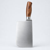 Single broad chopping knife with a brown handle on a light gray studio backdrop.