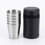 Four stainless steel travel cups stacked on the left next to a black textured cylindrical carrying case with a zipper, on a white background.