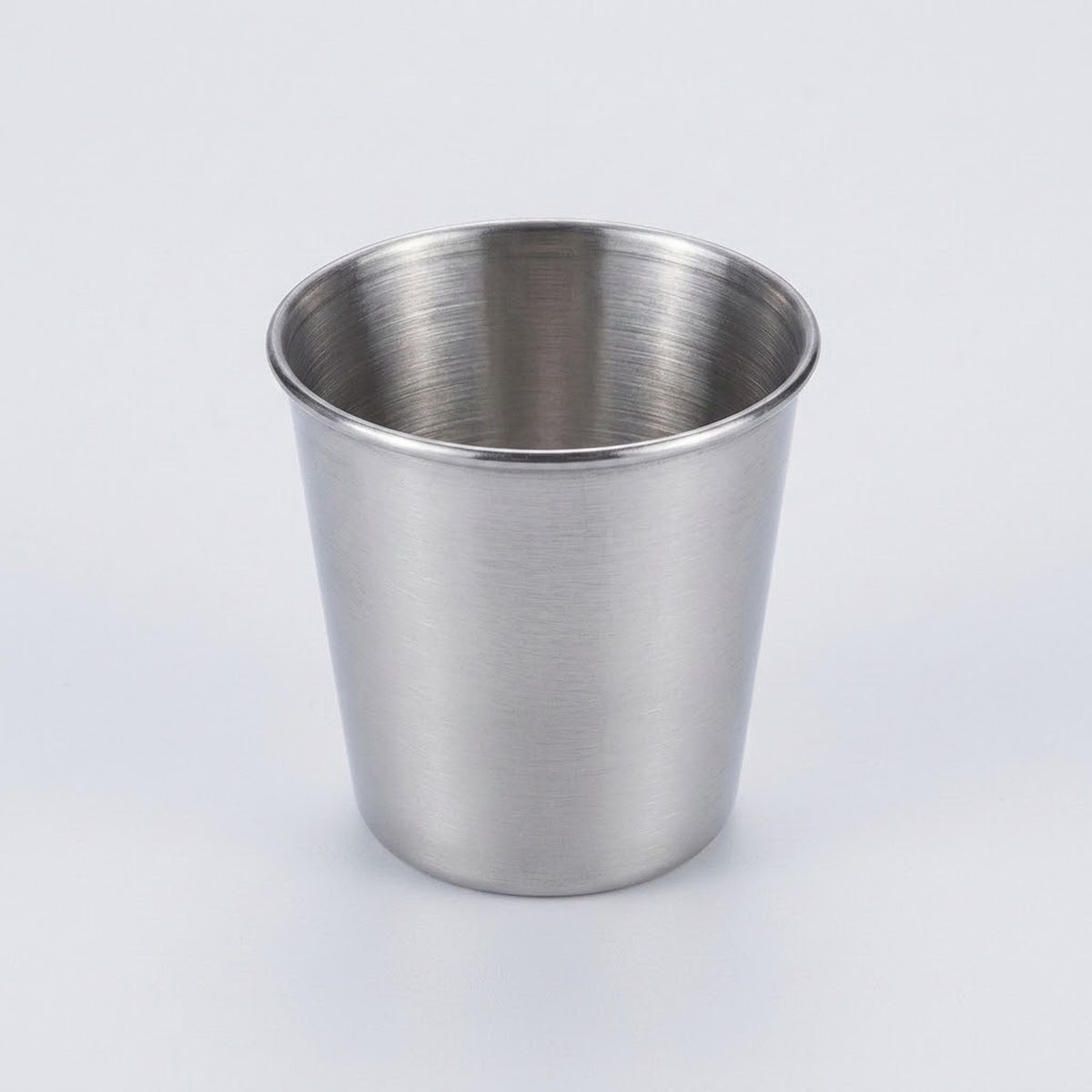 A brushed stainless steel cup with a tapered cylindrical shape, shown on a clean white background.