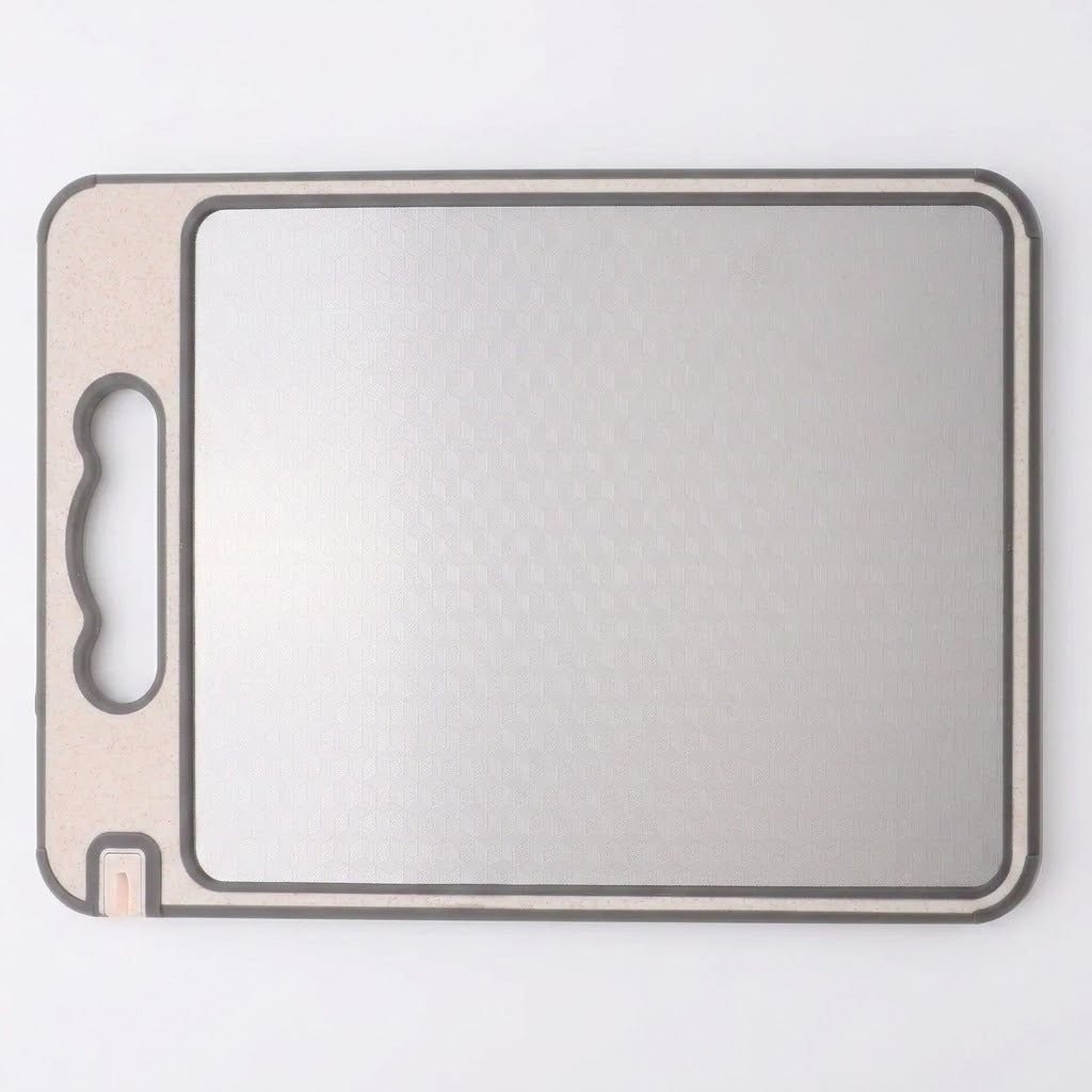 A square gray cutting board with rounded corners, a textured non-slip surface, and a built-in handle cutout on the left side, shown on a plain white background.