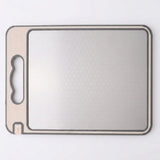 A square gray cutting board with rounded corners, a textured non-slip surface, and a built-in handle cutout on the left side, shown on a plain white background.