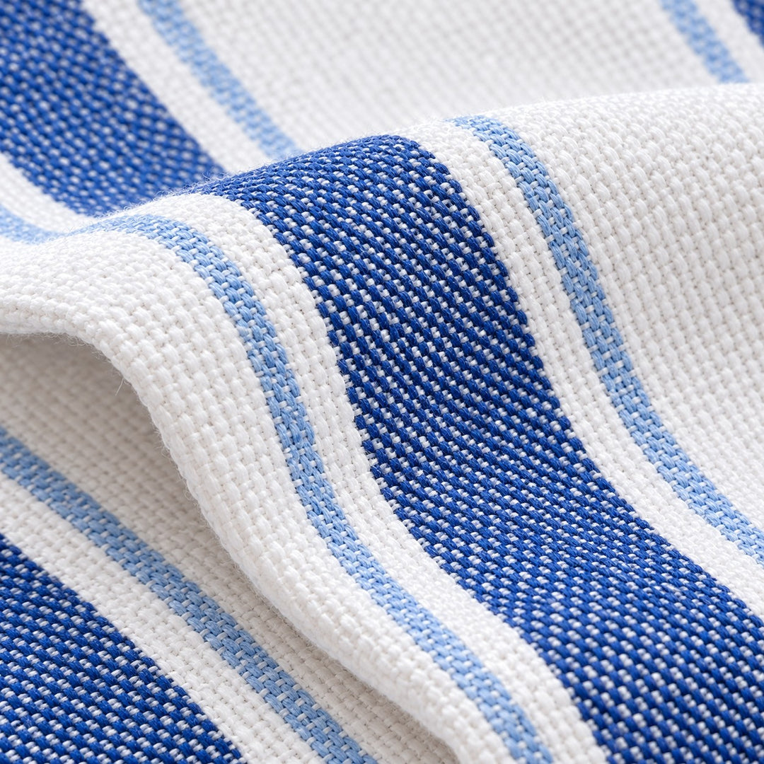 Close-up of the blue and white tea towel showing its textured woven cotton fibers.