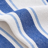 Close-up of the blue and white tea towel showing its textured woven cotton fibers.
