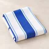 A folded blue striped cotton tea towel displays its woven texture and simple Nordic stripe pattern.