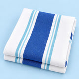 Blue striped cotton tea towel folded on a pale blue studio background.