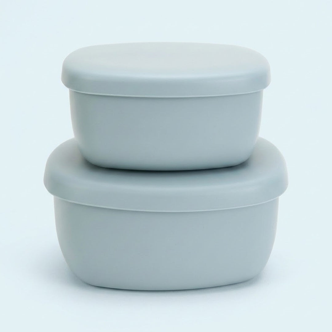 Two light gray silicone storage containers with matching lids, stacked neatly on a clean white background.