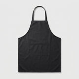 A black bib apron with a single neck strap and a front patch pocket, shown flat against a light gray background.