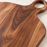 Handmade Acacia Cutting Board close-up showing warm wood grain and a smooth finished edge.