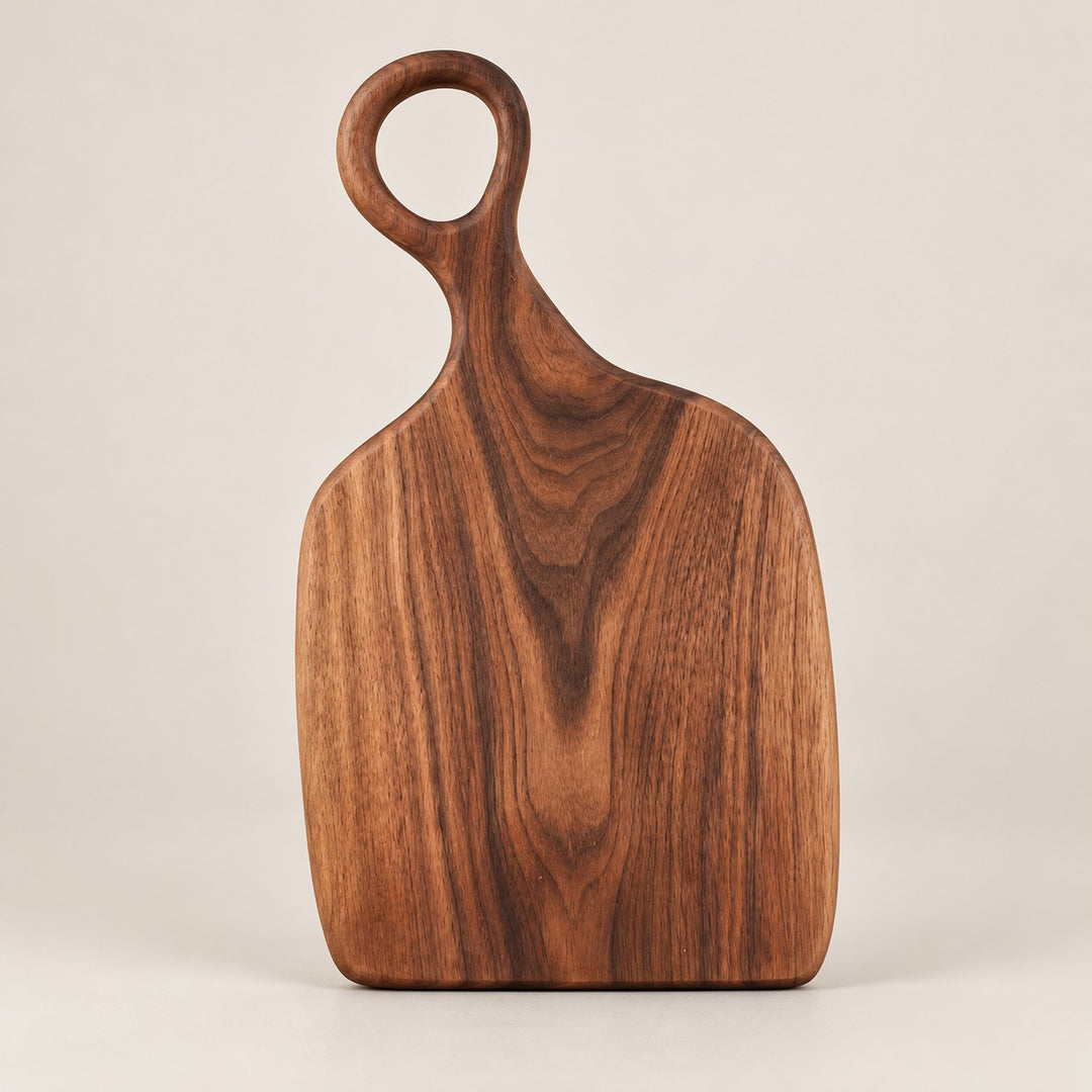 Handmade Acacia Cutting Board in the small size, showing its compact paddle shape and hanging hole.