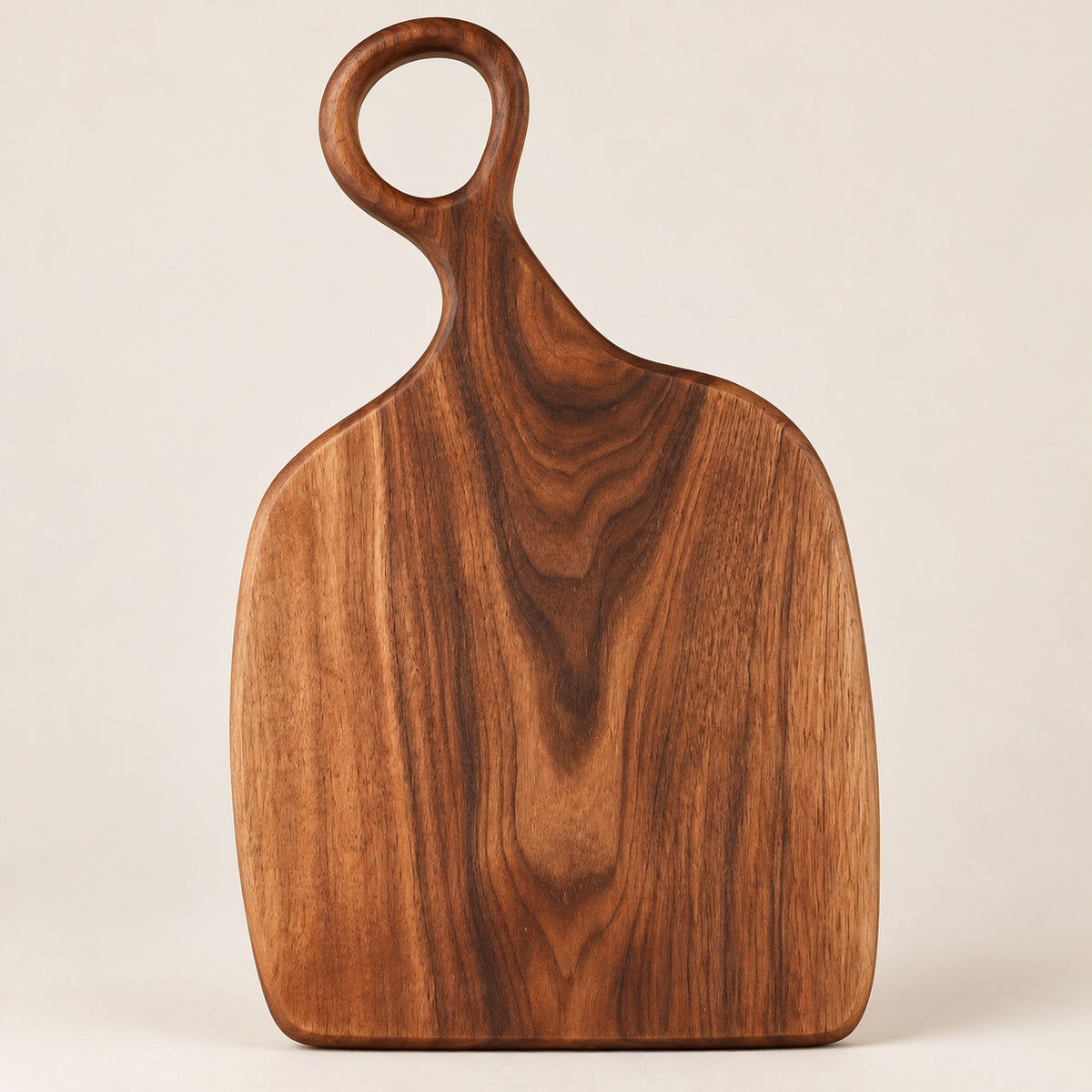 Handmade Acacia Cutting Board in the large size, showing its broad shape and hanging hole.