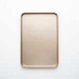 A rectangular metal baking pan with rounded corners, shown from a top-down view on a clean white background.