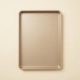 A rectangular metal baking sheet with raised rim, shown from a top-down view on a light beige background.